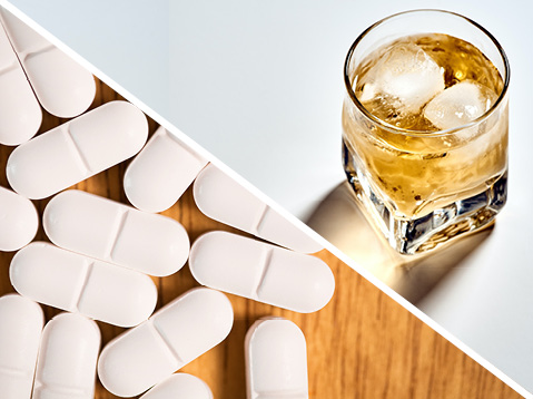 Glass of Alcohol Next to Opioid Pills