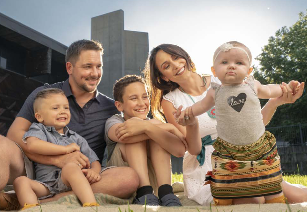 Family of Five Smiles at Youngest Child